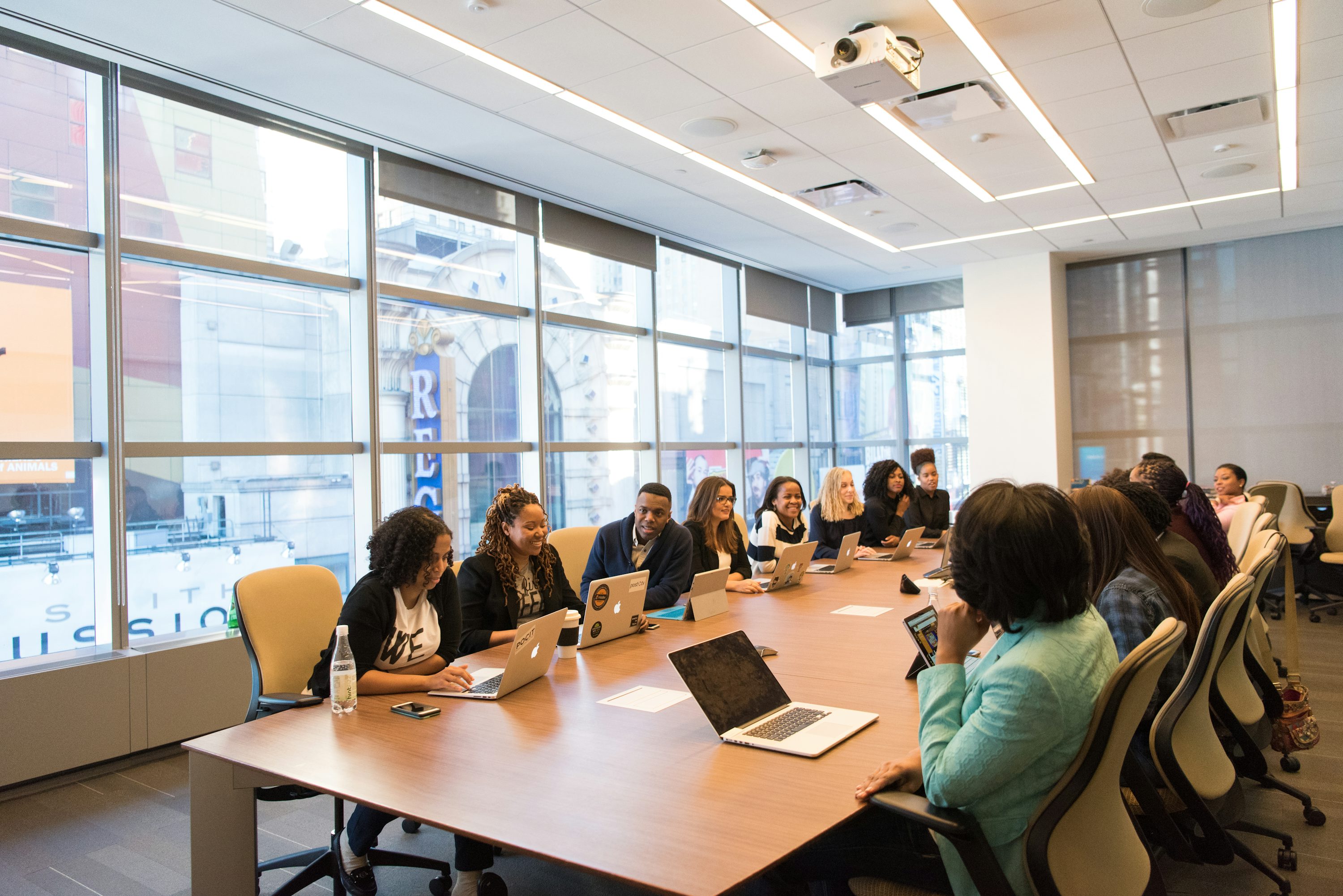 African professionals collaborating around a conference table in a bright office