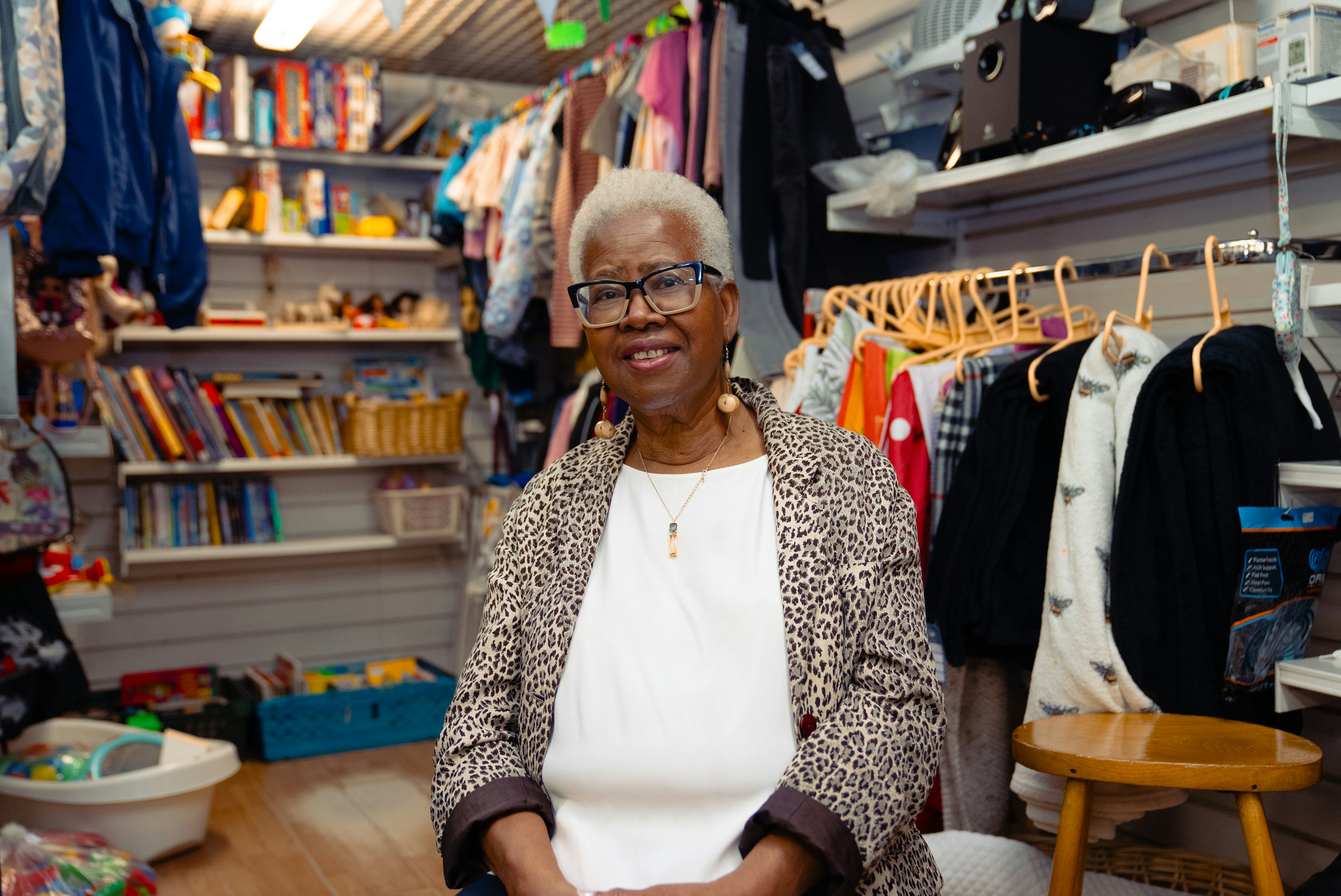 A smiling shop owner in her clothing store