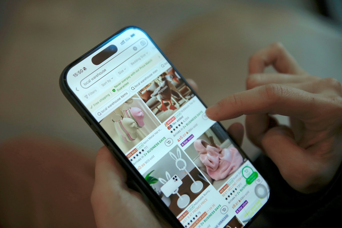 Hands scrolling through an online store on a smartphone